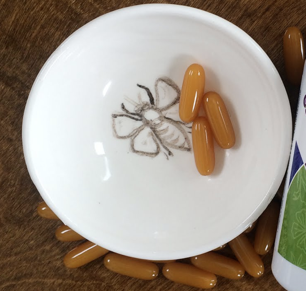 Natural bee supplements and fertility products on a decorative plate